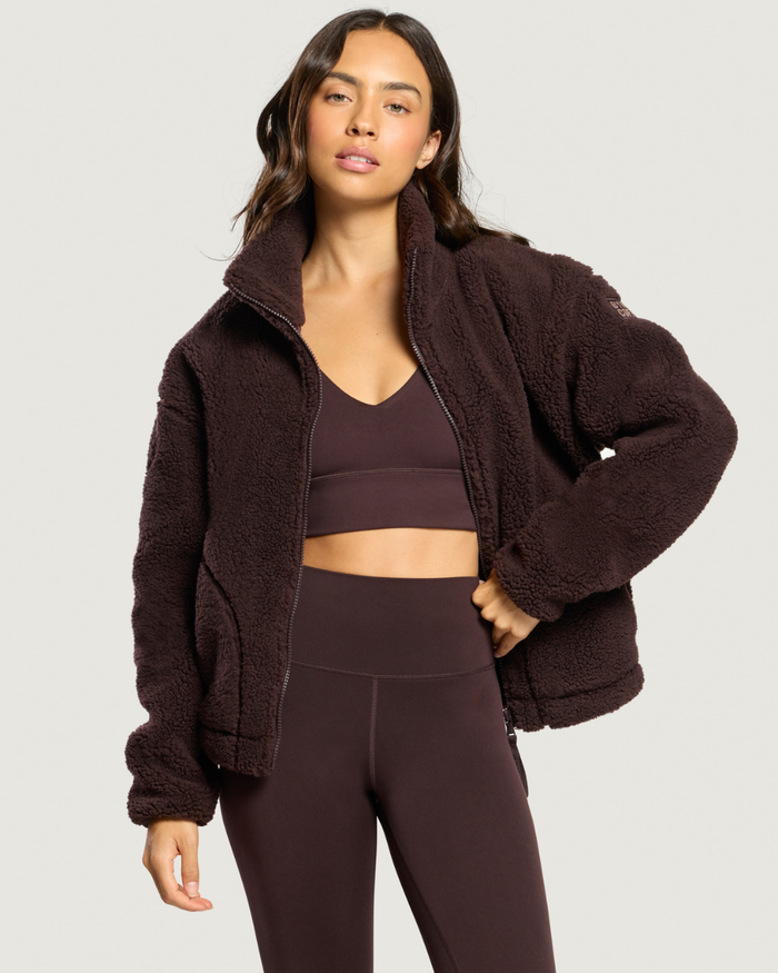 Woman wearing Gym+Coffee Industry Fleece High Collar Jacket Mocha Bean Shop Gym+Coffee at Dotique