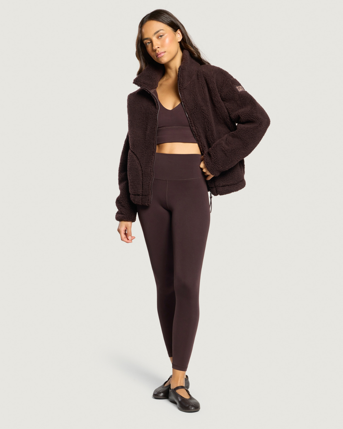Woman wearing Gym+Coffee Industry Fleece High Collar Jacket Mocha Bean Shop Gym+Coffee at Dotique