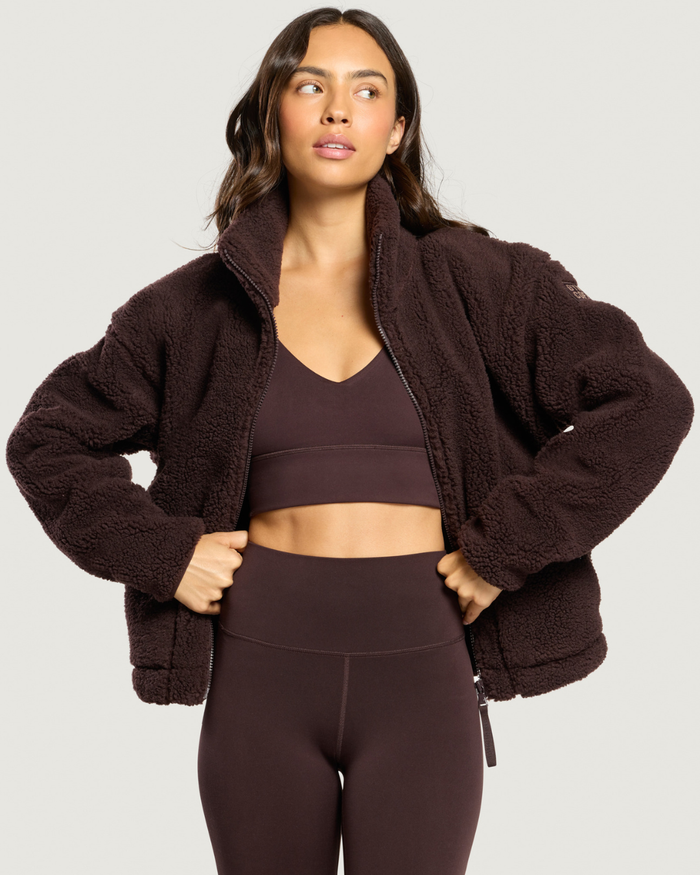 Woman wearing Gym+Coffee Industry Fleece High Collar Jacket Mocha Bean Shop Gym+Coffee at Dotique