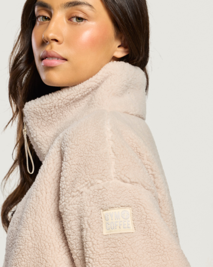 Close up of model wearing Gym+Coffee Industry Fleece High Collar Jacket Natural Shop Gym+Coffee at Dotique