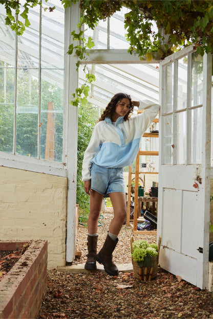 Gym+Coffee Snap Polar Fleece Glacial Blue worn by model in greenhouse Shop Gym+Coffee at Dotique