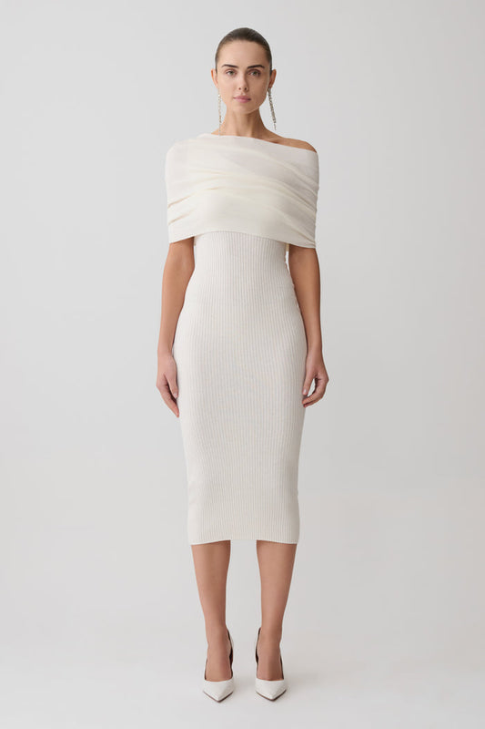 Woman wearing a white off-shoulder dress on a light gray background